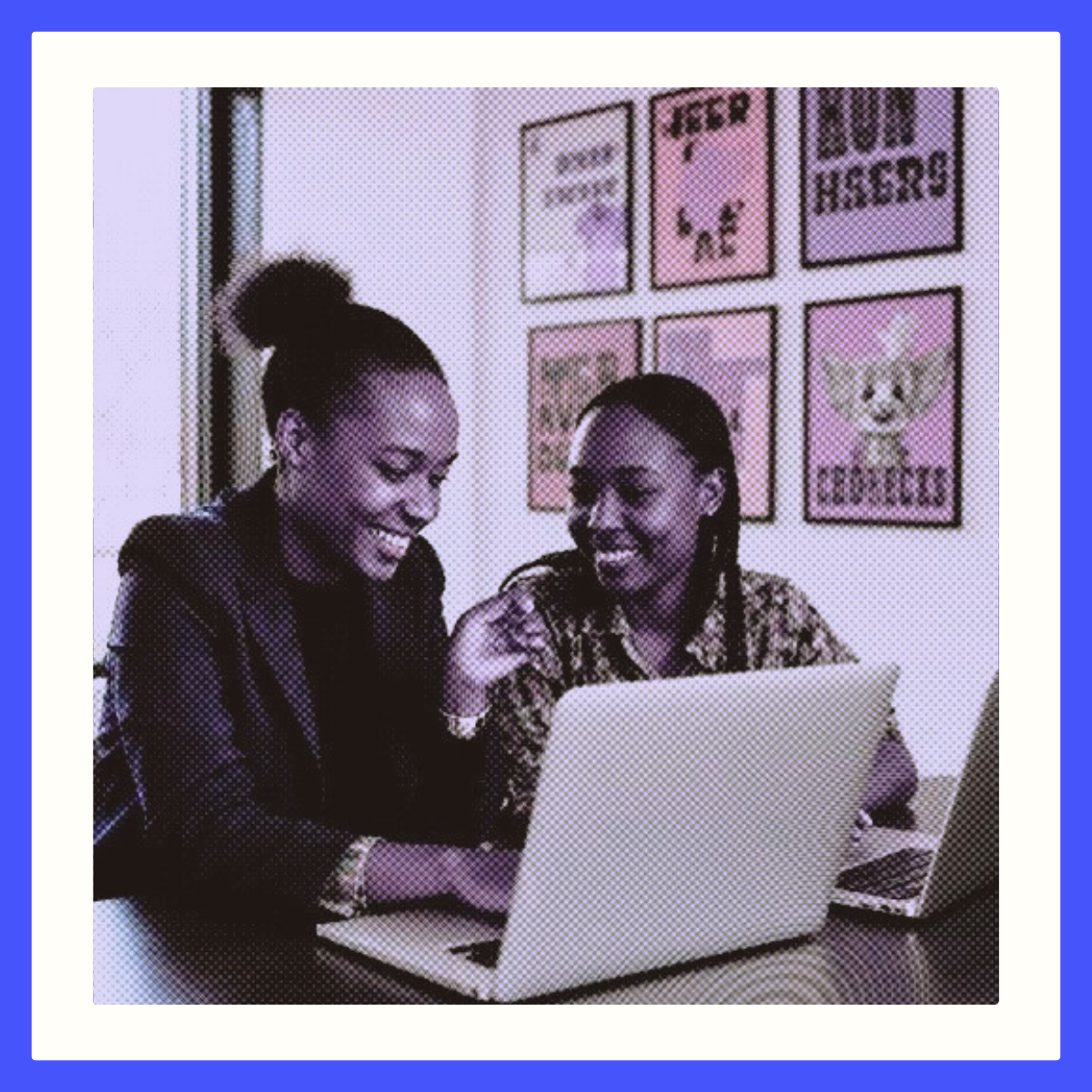 Two professionals collaborating on a laptop in a creative office